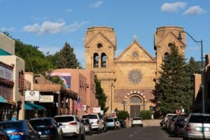 cars parked in front of brown concrete building during daytime