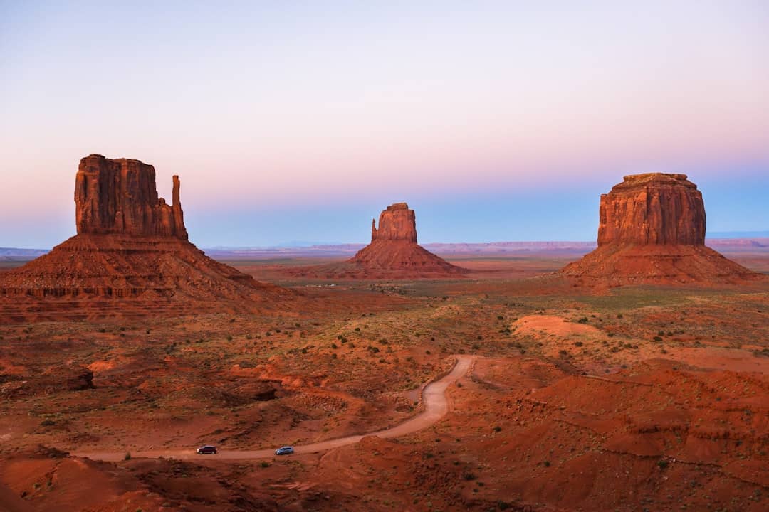 Photo by Gantavya Bhatt a dirt road in the middle of a desert
