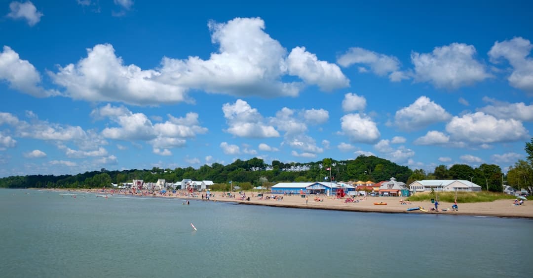 A sunny day at a crowded beach with blue skies.