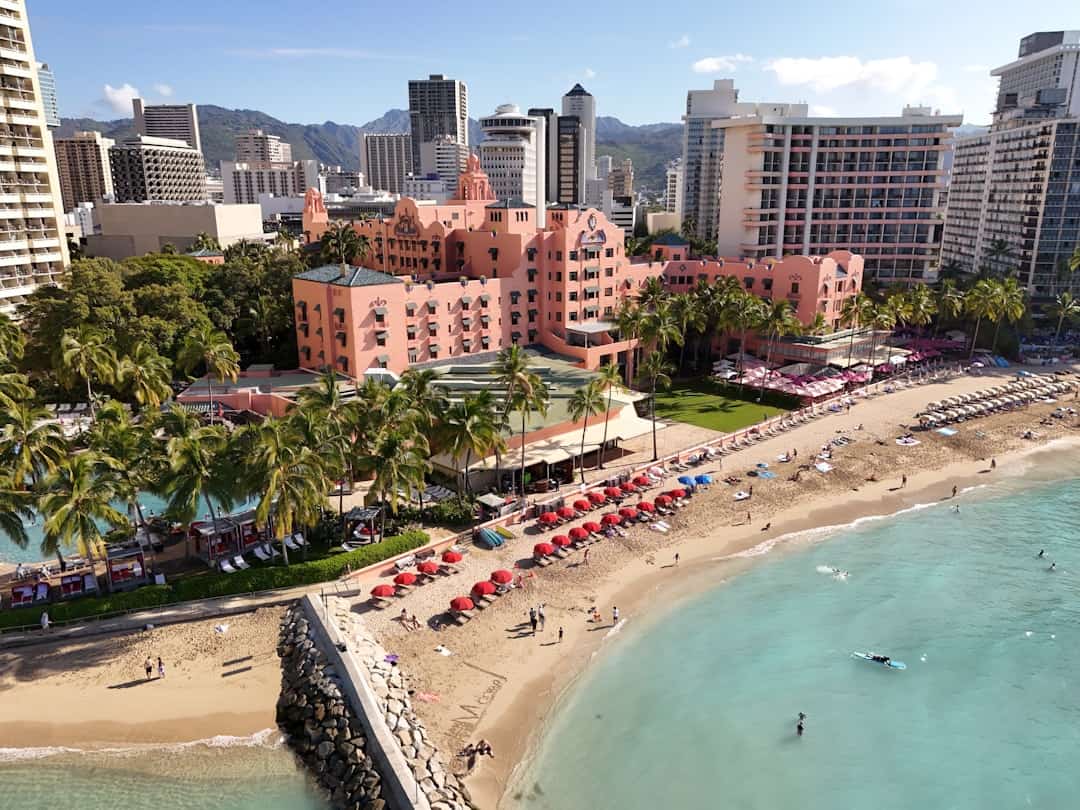 Photo by User_Pascal Beautiful beach scene with a resort and city skyline.