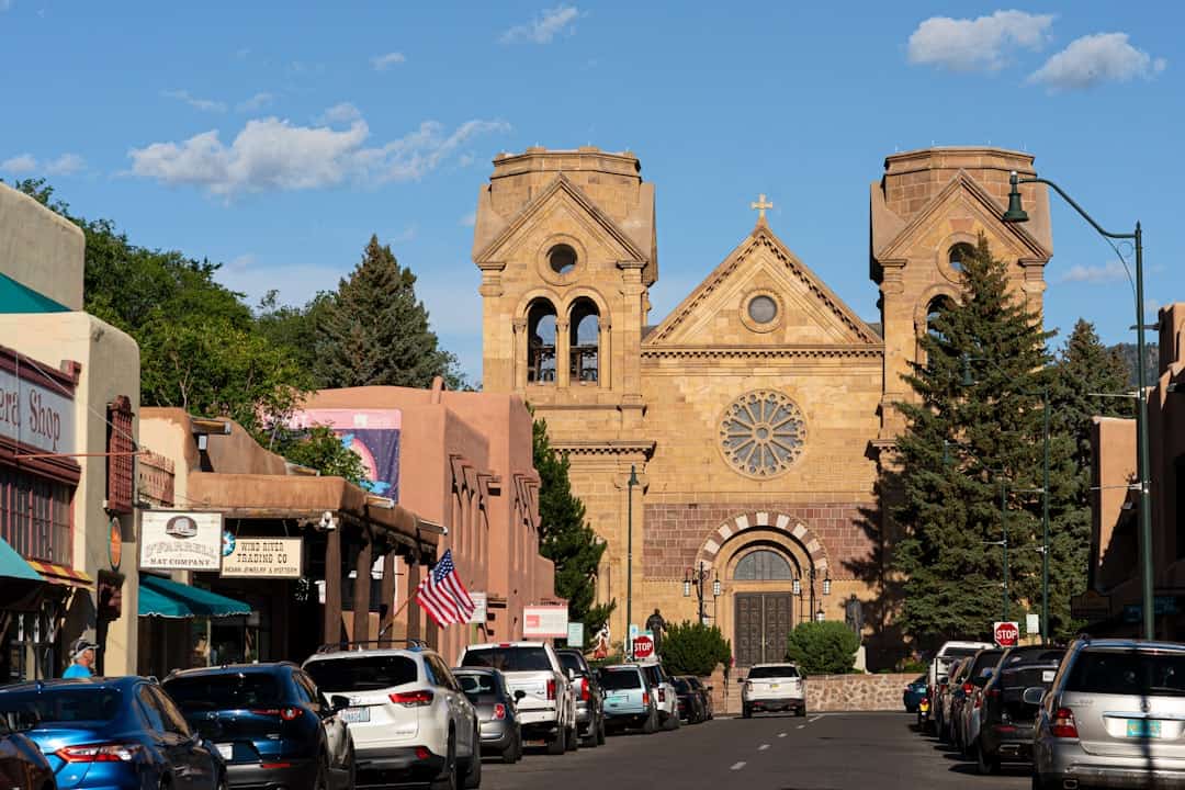 cars parked in front of brown concrete building during daytime