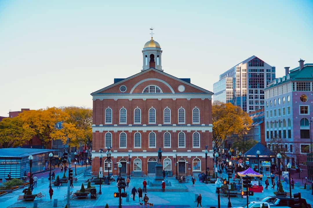 a large brick building with a dome with Faneuil Hall in the background