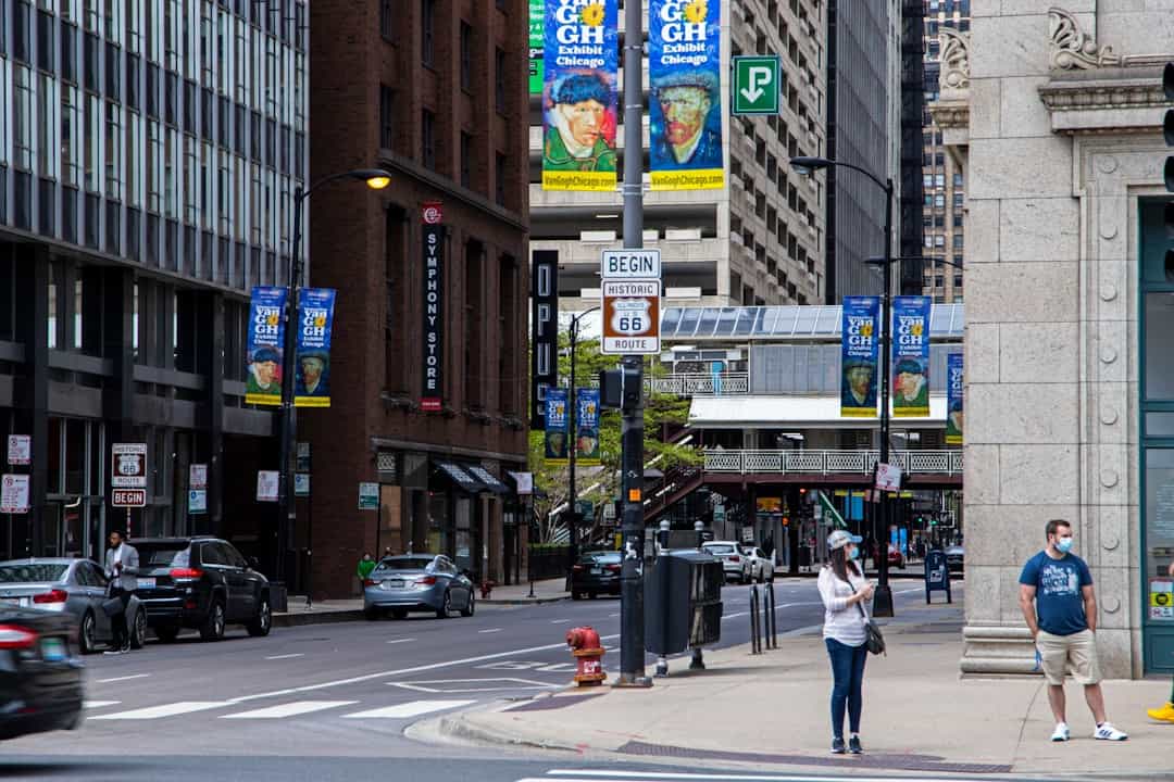 a woman standing on a sidewalk next to a traffic light