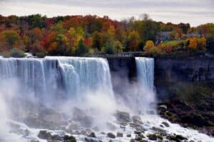 a waterfall with trees in the background