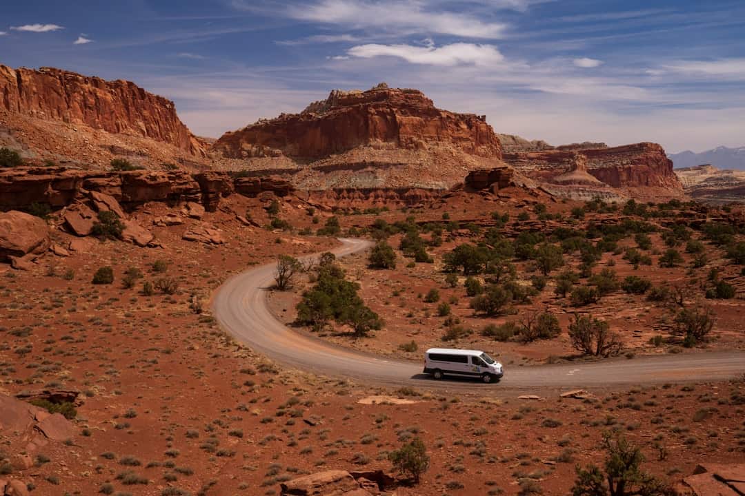 a van driving down a road in the desert
