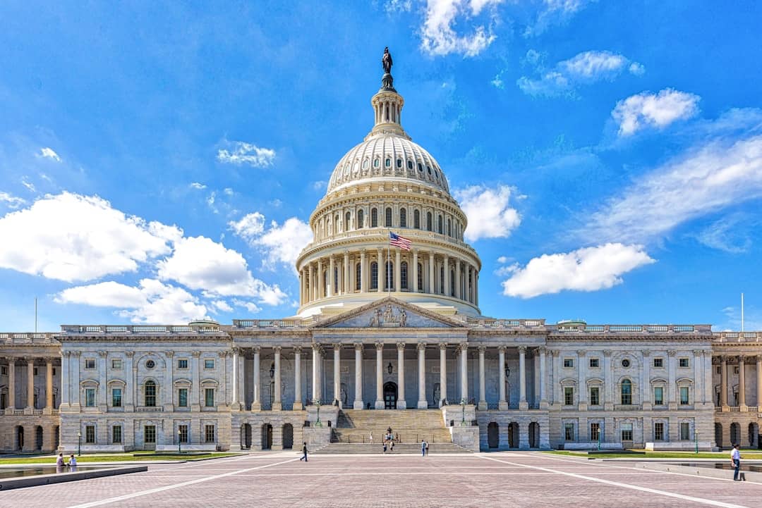 a large building with a dome and a flag on top with United States Capitol in the background