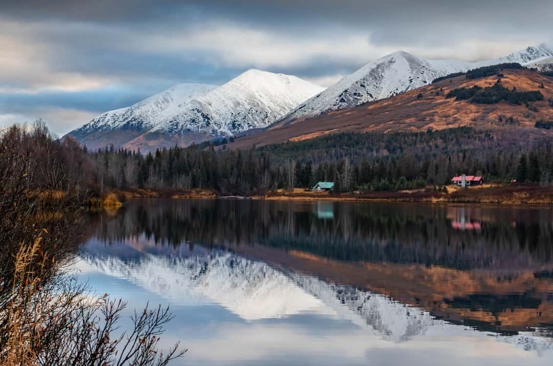 Snow-capped mountains reflected in a calm lake