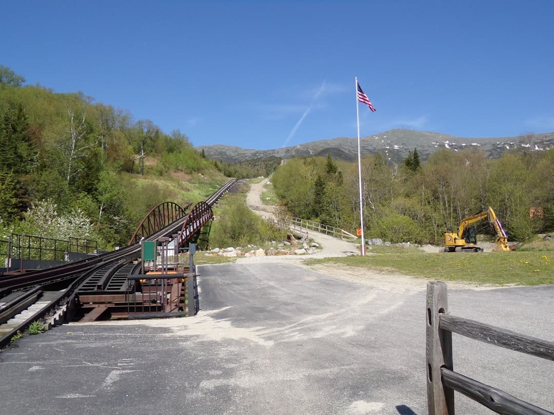 Photo by Stephen Costo a train track with a flag on top of it