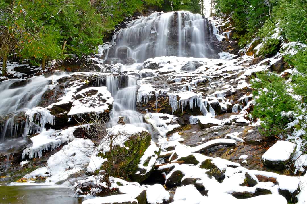 Photo by Tyke Jones water falls on rocky ground
