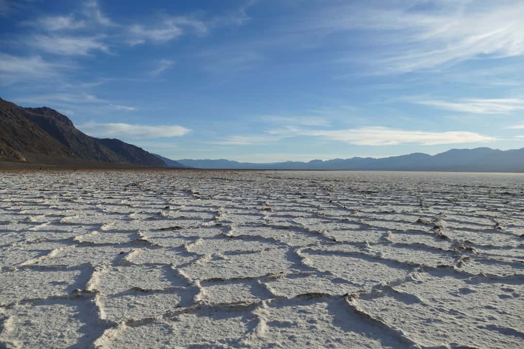 a large flat area with mountains in the background